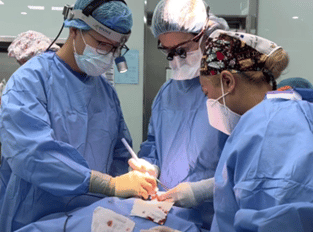 doctors performing surgery using enova led headlights